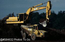 Backhoe scooping dirt