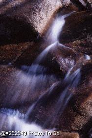 Mountain stream flowing over granite rock